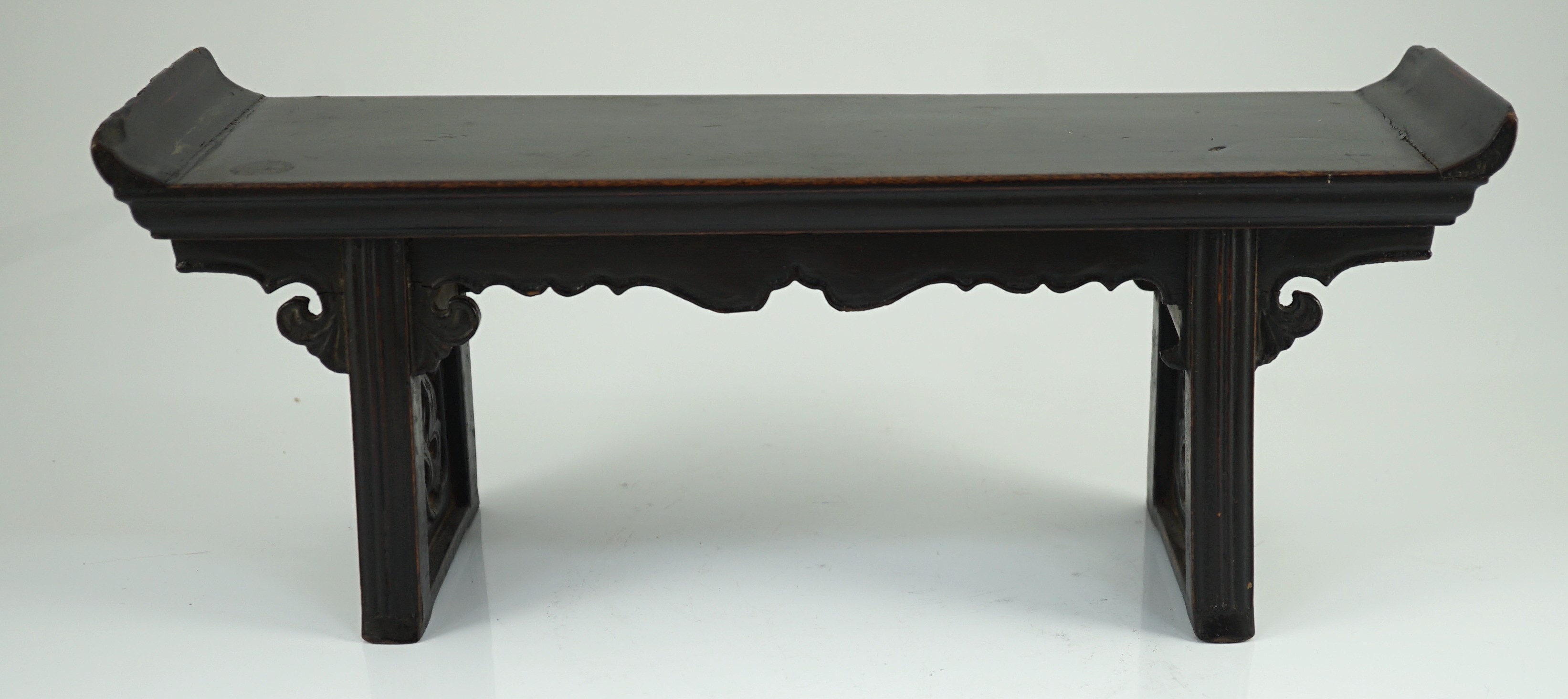 A Chinese late Ming lacquered wood model of an altar table, 17th century, 41cm wide, 16.5cm high, minor losses